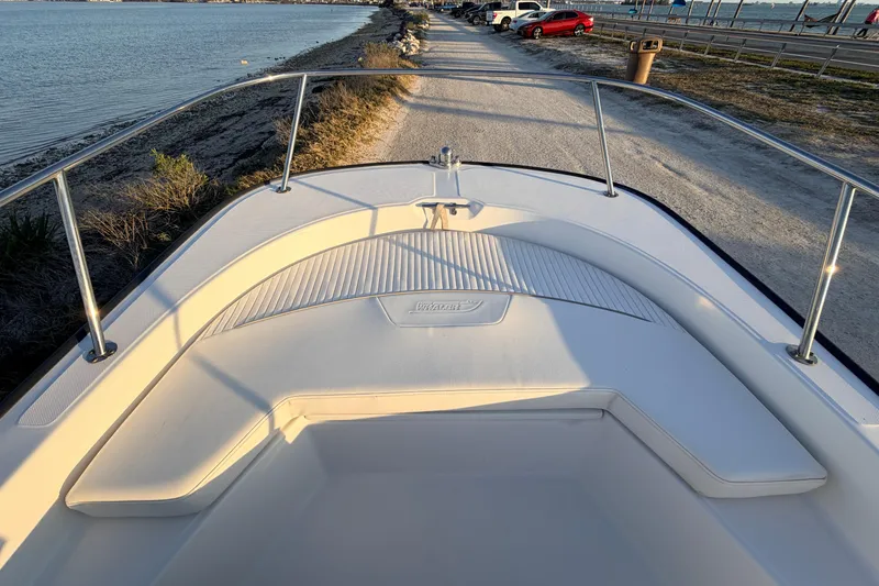 Slide: The Image of Bow view of a 2010 Boston Whaler 170 Montauk boat docked by the shore. - 19