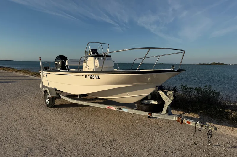 Slide: The Image of 2010 Boston Whaler 170 Montauk boat on trailer by the water. - 2