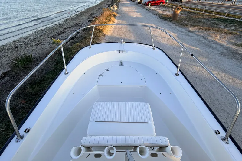 Slide: The Image of 2010 Boston Whaler 170 Montauk boat docked near a sandy beach. - 22