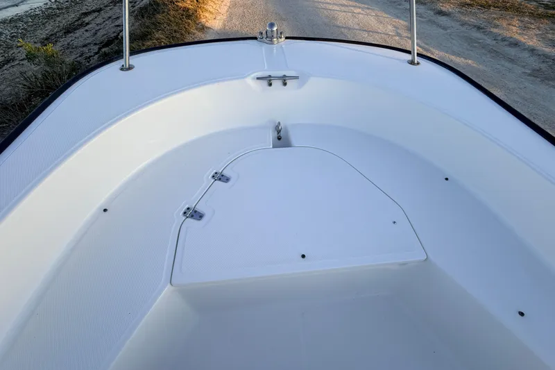 Slide: The Image of 2010 Boston Whaler 170 Montauk boat interior, showcasing clean white deck and storage hatch. - 23