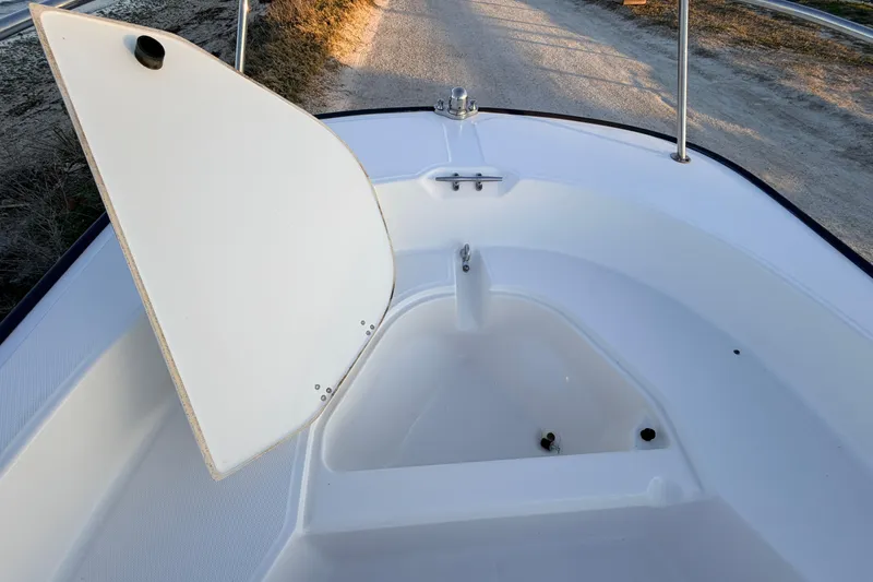 Slide: The Image of 2010 Boston Whaler 170 Montauk boat interior with open storage compartment. - 24