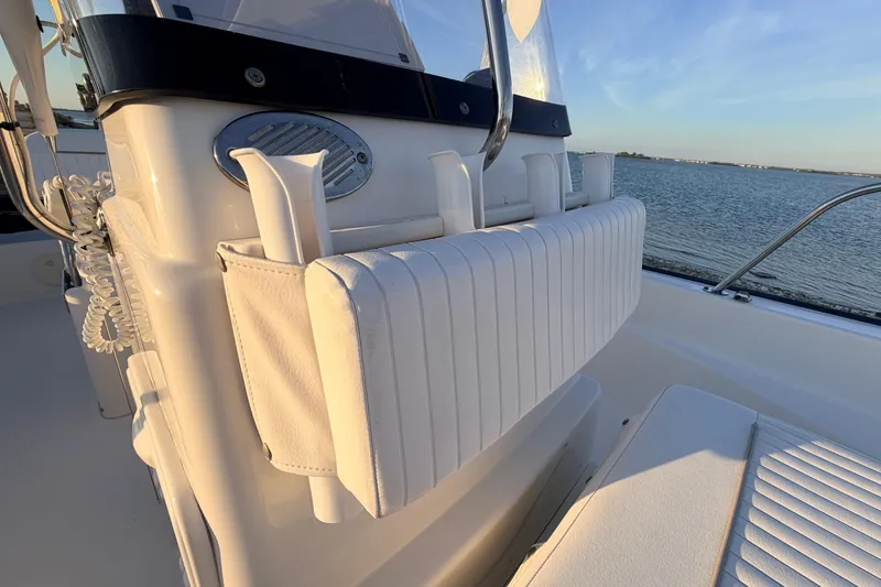 Slide: The Image of 2010 Boston Whaler 170 Montauk boat interior with white seating, overlooking calm waters. - 27