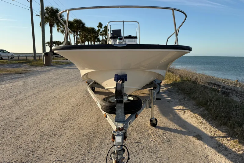 Slide: The Image of 2010 Boston Whaler 170 Montauk boat on trailer by the beach. - 3