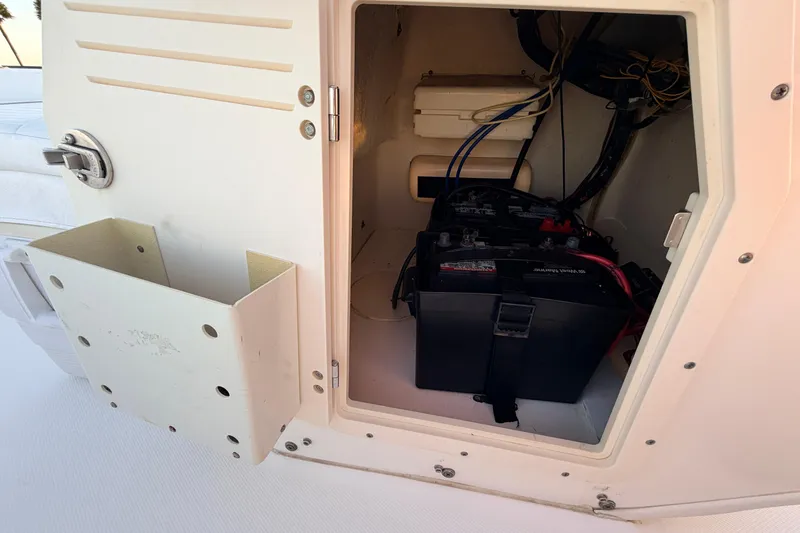 Slide: The Image of Open storage compartment on a 2010 Boston Whaler 170 Montauk boat, showing battery and wiring. - 30
