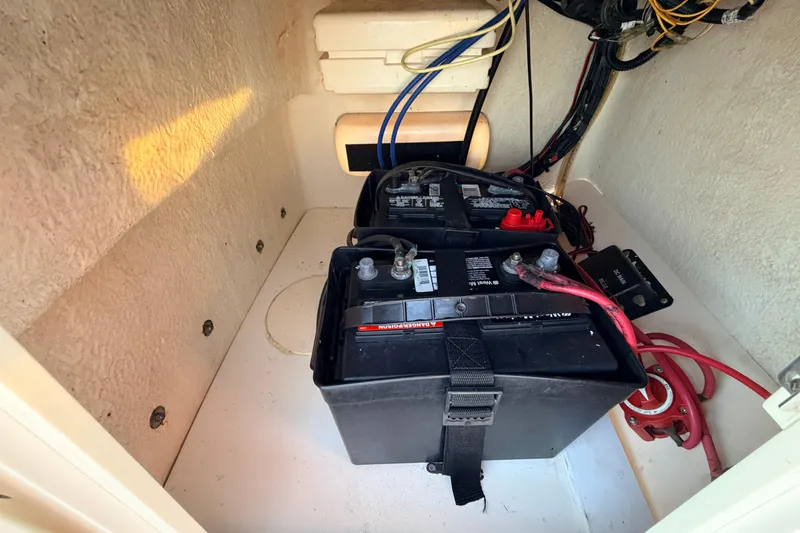Slide: The Image of Battery compartment of a 2010 Boston Whaler 170 Montauk boat, showing wiring and connections. - 31