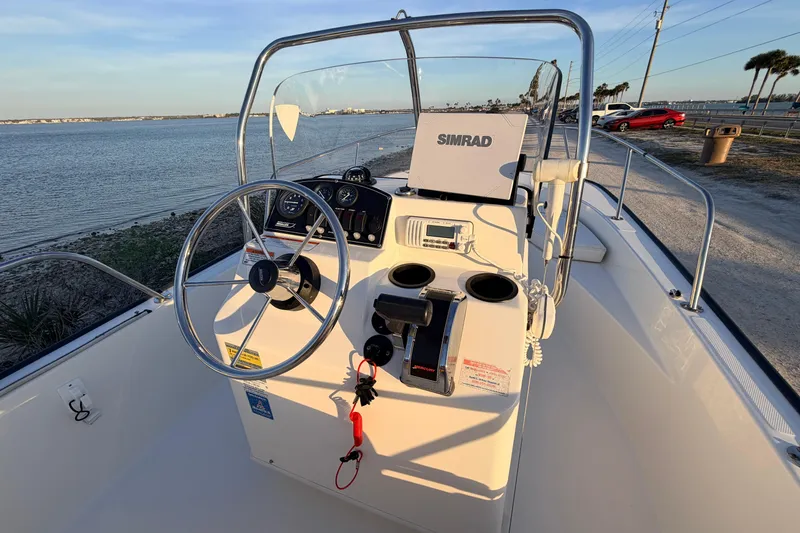 Slide: The Image of 2010 Boston Whaler 170 Montauk boat interior with steering wheel and Simrad navigation system. - 33