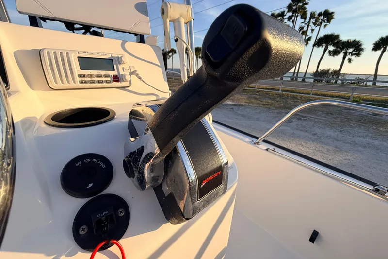 Slide: The Image of Control panel of a 2010 Boston Whaler 170 Montauk boat with throttle and radio. - 35