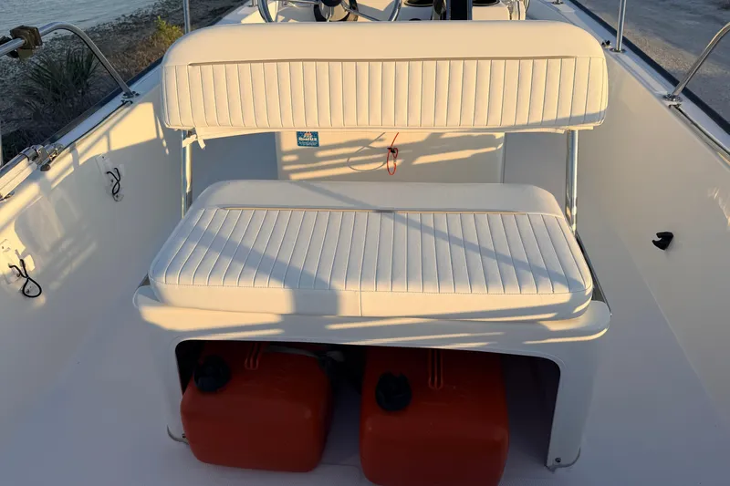 Slide: The Image of Boston Whaler 170 Montauk 2010 boat interior with cushioned seating and storage area. - 40