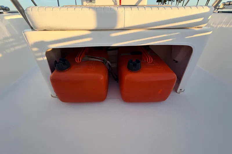 Slide: The Image of Storage compartment with orange fuel tanks on a 2010 Boston Whaler 170 Montauk boat. - 43