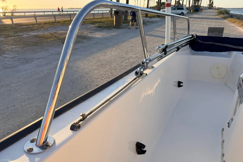 Slide: The Image of 2010 Boston Whaler 170 Montauk boat interior with stainless steel railing at sunset. - 44
