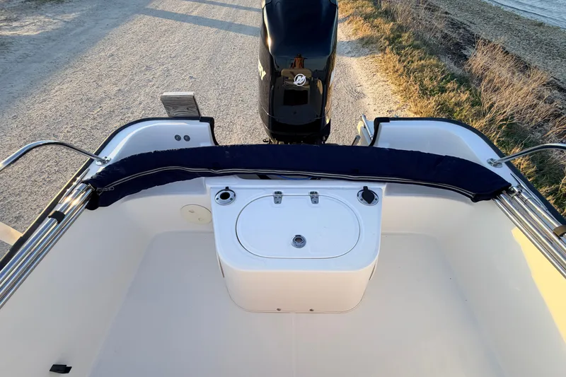 Slide: The Image of 2010 Boston Whaler 170 Montauk boat interior with motor and seating area. - 46