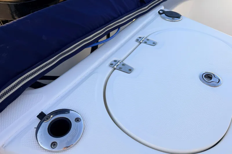 Slide: The Image of 2010 Boston Whaler 170 Montauk boat deck with storage hatch and rod holder. - 49