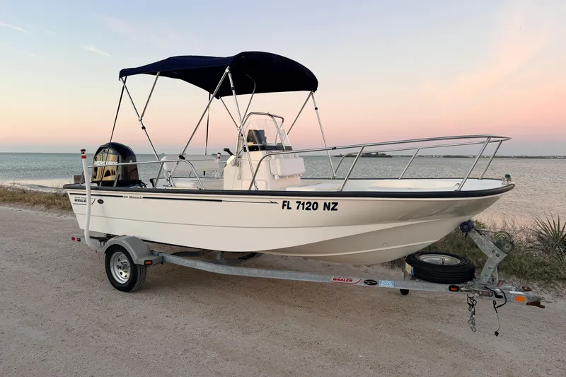 Slide: The Image of 2010 Boston Whaler 170 Montauk boat on trailer by the seaside at sunset. - 54