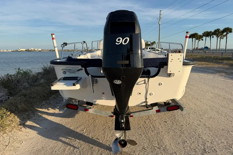 Slide: The Image of 2010 Boston Whaler 170 Montauk boat with 90 HP engine, parked near waterfront. - 7