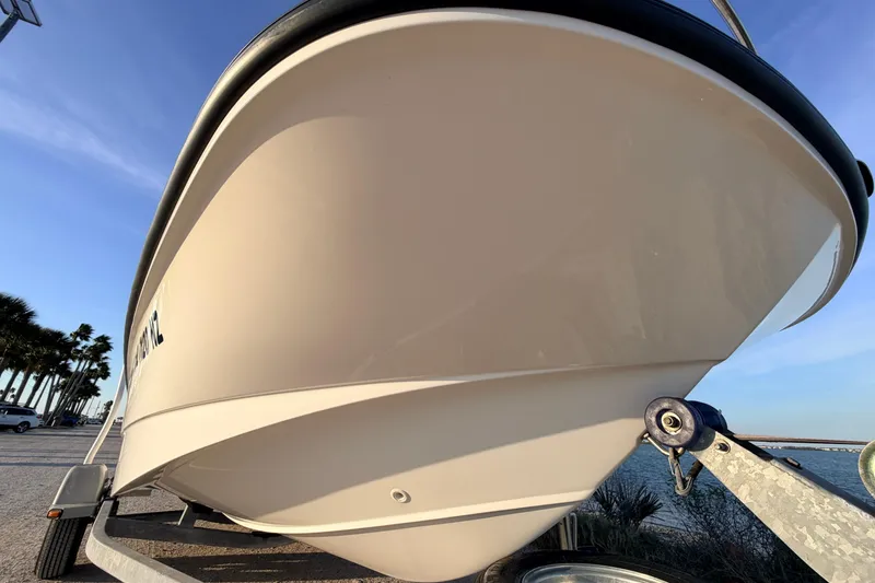 Slide: The Image of 2010 Boston Whaler 170 Montauk boat on trailer, coastal background. - 9