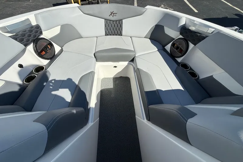 Slide: The Image of 2023 MasterCraft XT22 boat interior with gray seating and cup holders. - 7
