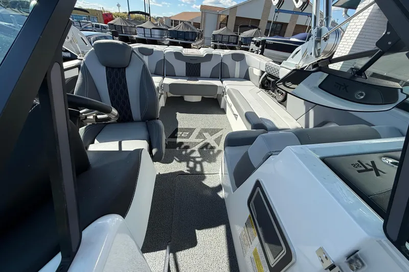 Slide: The Image of 2023 MasterCraft XT22 boat interior with modern seating and sleek design. - 9