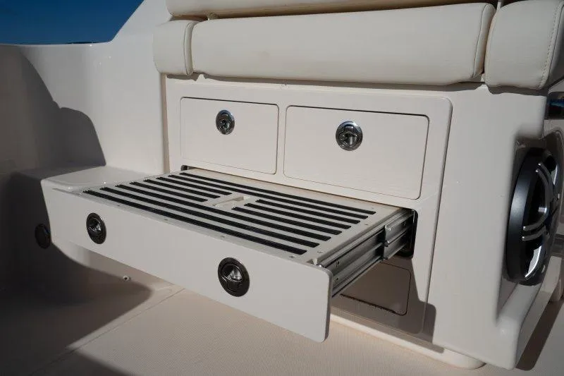 Slide: The Image of 2026 Grady-White Express 340 boat interior with open storage compartment and drawers. - 10