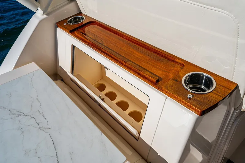 Slide: The Image of Manufacturer Provided Image: 2026 Grady-White Express 340 boat interior with wooden countertop and cup holders. - 11