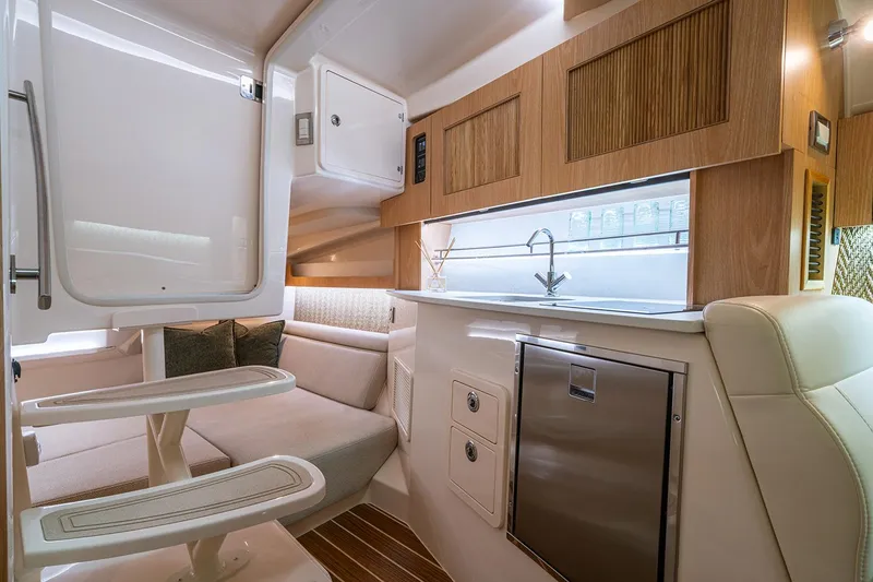 Slide: The Image of Manufacturer Provided Image: Interior of 2026 Grady-White Express 340 boat, featuring modern kitchen and seating area. - 18