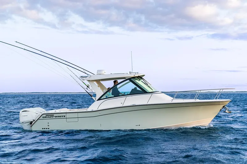Slide: The Image of Manufacturer Provided Image: 2026 Grady-White Express 340 boat cruising on open water under a cloudy sky. - 2