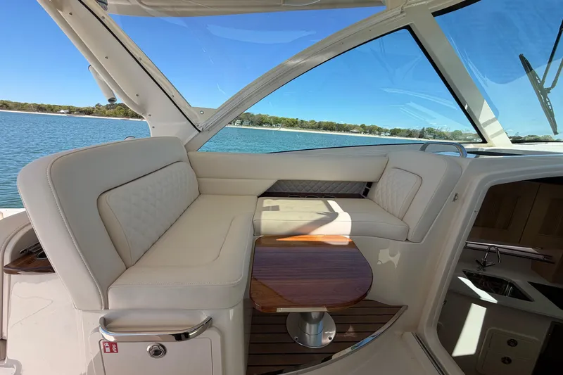 Slide: The Image of Luxurious interior of 2026 Grady-White Express 340 yacht with elegant seating and table. - 25