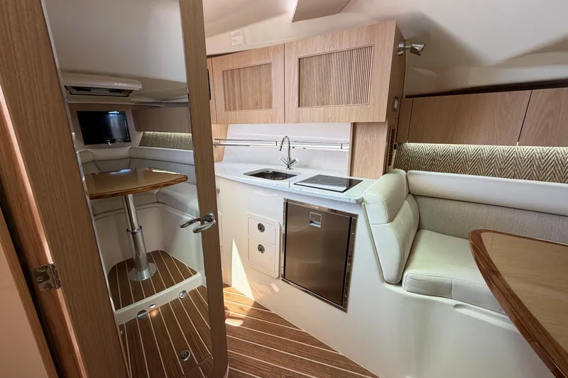 Slide: The Image of Luxurious interior of 2026 Grady-White Express 340 boat with modern kitchen and seating area. - 29