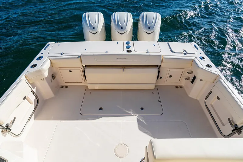 Slide: The Image of Manufacturer Provided Image: 2026 Grady-White Express 340 boat deck with triple outboard motors on water. - 3