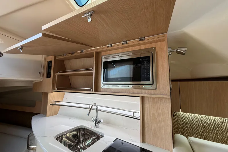 Slide: The Image of Interior of 2026 Grady-White Express 340 boat with modern kitchen amenities. - 33