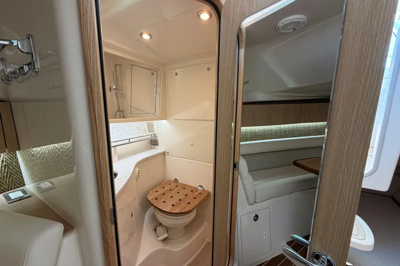Slide: The Image of Luxurious interior of 2026 Grady-White Express 340 boat, featuring a modern bathroom and seating area. - 34