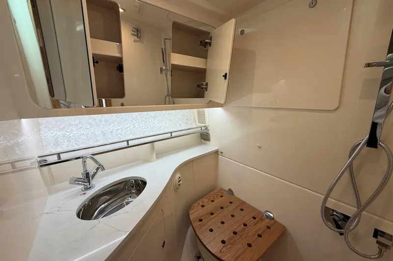 Slide: The Image of Luxurious bathroom in 2026 Grady-White Express 340 yacht with modern fixtures and wooden seat. - 36
