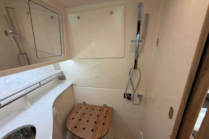 Slide: The Image of Bathroom interior of 2026 Grady-White Express 340 boat with shower and wooden seat. - 38