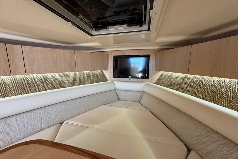 Slide: The Image of Luxurious interior of 2026 Grady-White Express 340 boat with cozy seating and TV. - 39