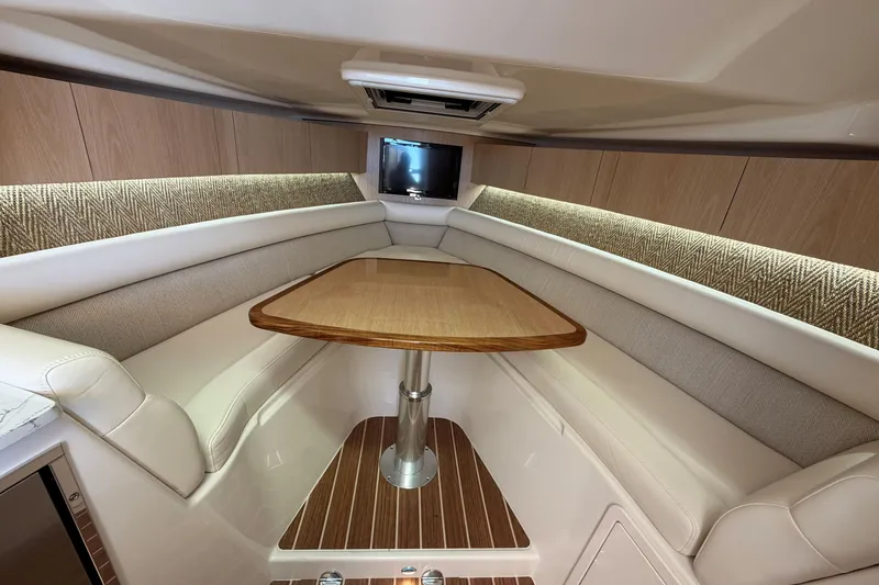 Slide: The Image of Luxurious interior of 2026 Grady-White Express 340 boat with elegant seating and wooden table. - 40