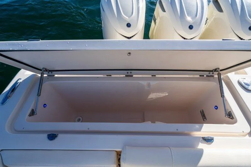 Slide: The Image of Open storage compartment on 2026 Grady-White Express 340 boat, with outboard motors visible. - 5
