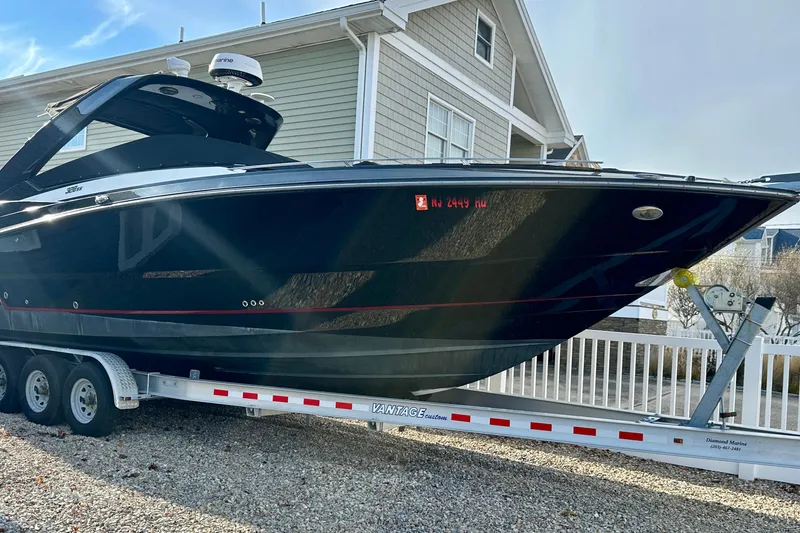Slide: The Image of 2013 Monterey 328SS Super Sport boat on trailer, parked near a house. - 14