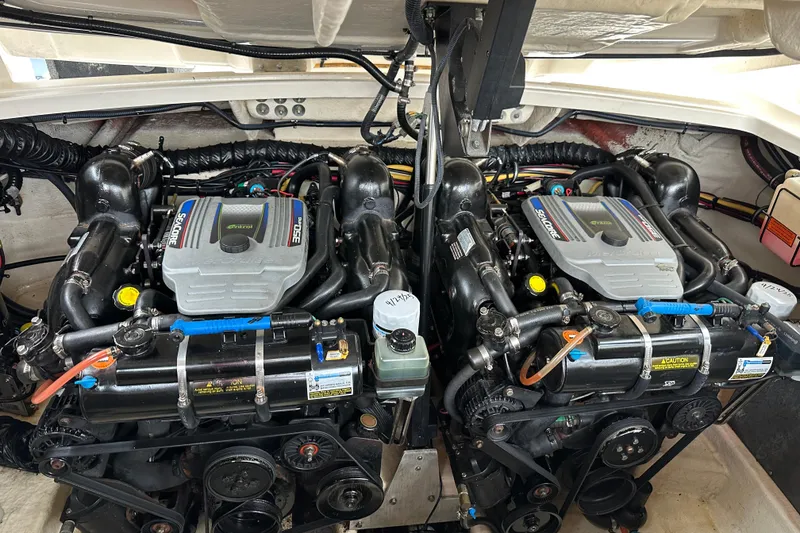 Slide: The Image of Twin engines of a 2013 Monterey 328SS Super Sport boat, showcasing detailed mechanics. - 19