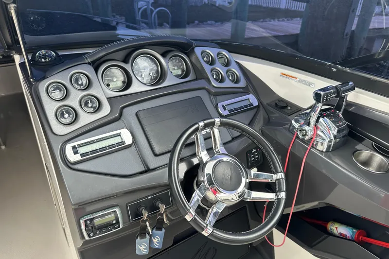 Slide: The Image of Dashboard of a 2013 Monterey 328SS Super Sport boat with steering wheel and controls. - 3