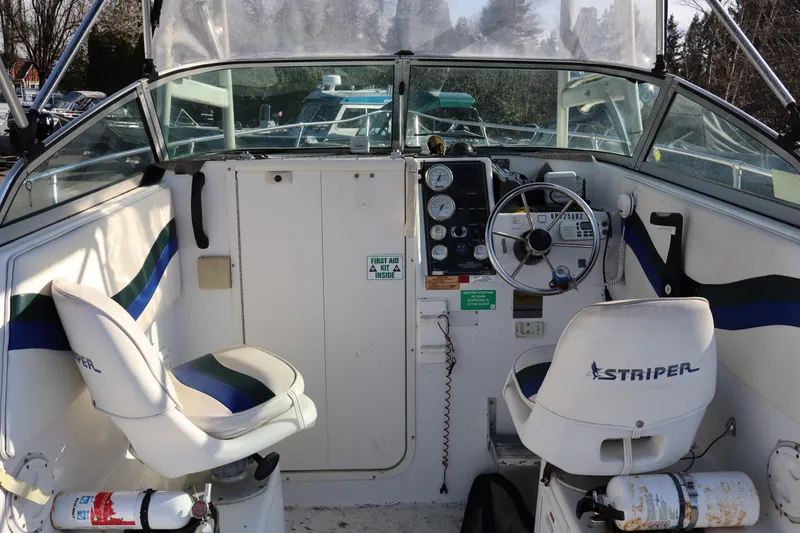 Slide: The Image of Interior view of a 2000 Seaswirl Striper 2300 Walkaround O/B boat cockpit. - 3