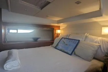 Slide: The Image of Luxurious cabin interior of a 2013 Prestige 550 yacht with cozy bedding and ambient lighting. - 19
