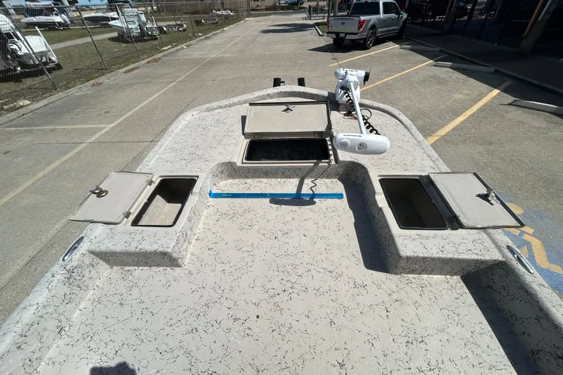 Slide: The Image of 2015 Shallow Stalker Cat 240 Pro boat deck with storage compartments and trolling motor. - 11