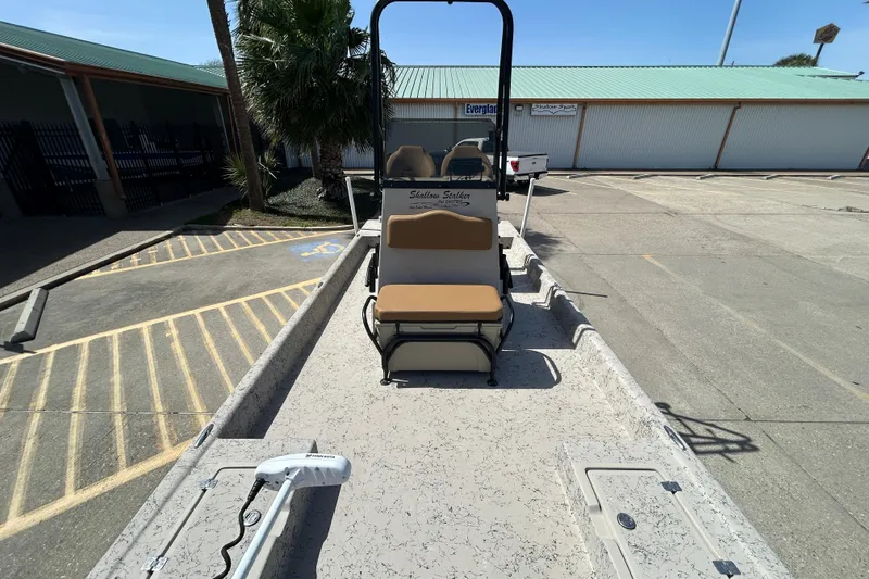 Slide: The Image of 2015 Shallow Stalker Cat 240 Pro boat in parking lot, featuring seating and trolling motor. - 12