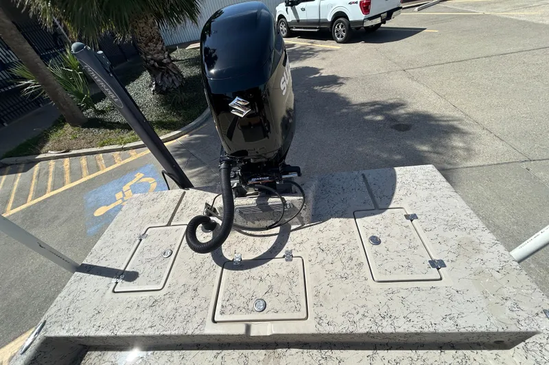 Slide: The Image of 2015 Shallow Stalker Cat 240 Pro boat with Suzuki outboard motor in parking lot. - 13