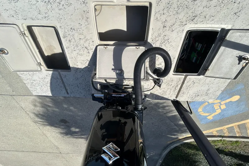 Slide: The Image of Overhead view of a 2015 Shallow Stalker Cat 240 Pro boat engine near storage compartments. - 14