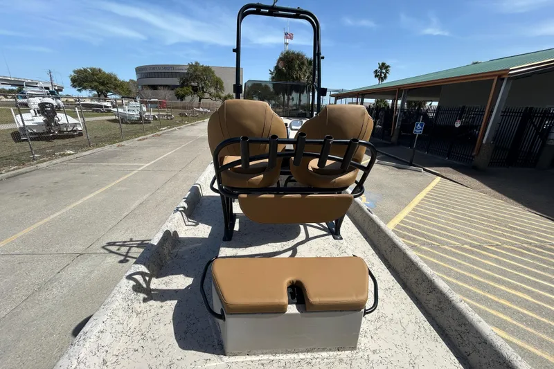 Slide: The Image of 2015 Shallow Stalker Cat 240 Pro boat with tan seating, parked outdoors. - 15