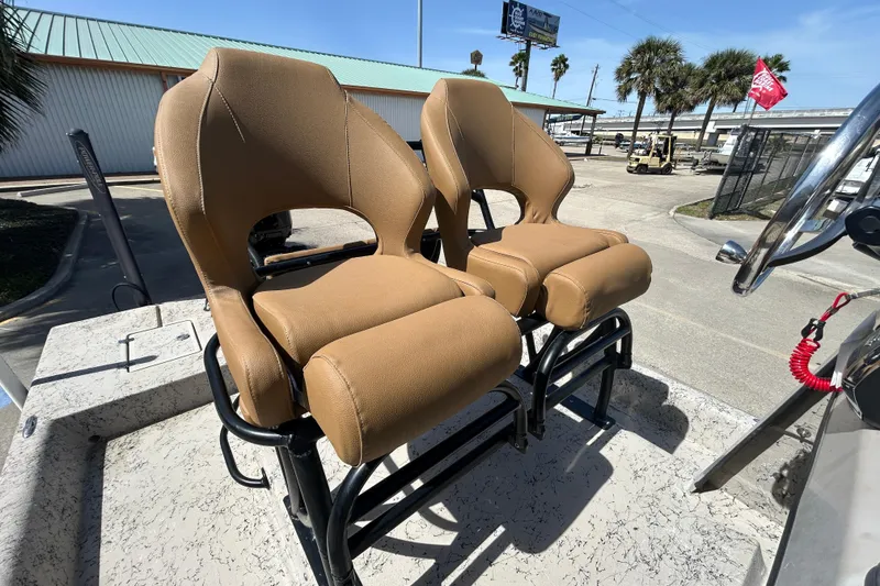Slide: The Image of Two tan boat seats on a 2015 Shallow Stalker Cat 240 Pro. - 18