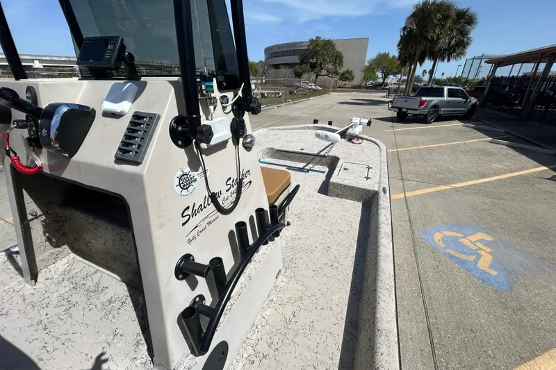 Slide: The Image of 2015 Shallow Stalker Cat 240 Pro boat parked in a lot with palm trees. - 19