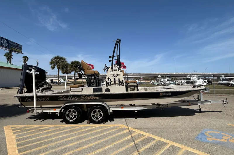 Slide: The Image of 2015 Shallow Stalker Cat 240 Pro boat on trailer, parked outdoors under clear sky. - 5