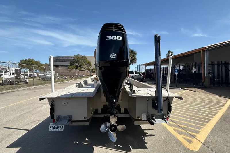 Slide: The Image of 2015 Shallow Stalker Cat 240 Pro boat with powerful 300 HP engine, parked outdoors. - 7