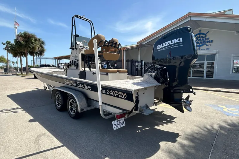 Slide: The Image of 2015 Shallow Stalker Cat 240 Pro boat with Suzuki engine on trailer. - 8